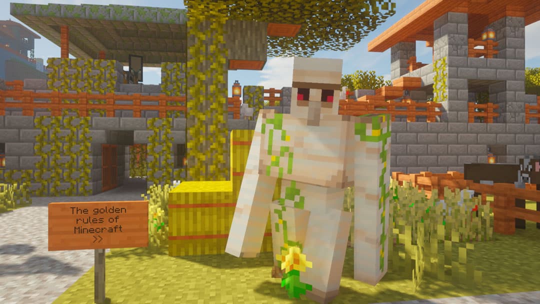 An iron golem beside hay bales and a sign about the golden rules of Minecraft in a village courtyard.